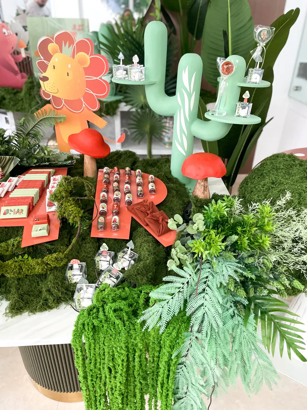 Green jungle newborn setup with terracotta chocolates and ferns