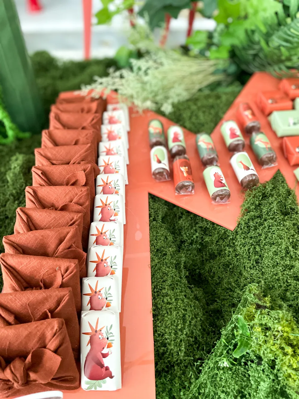 Jungle themed dessert display with giraffe and greenery