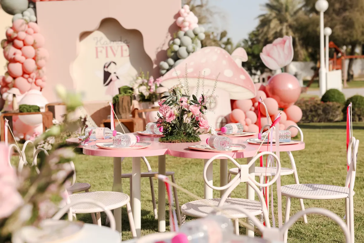 A pink fairy garden birthday with styled garden tables in a Dubai garden